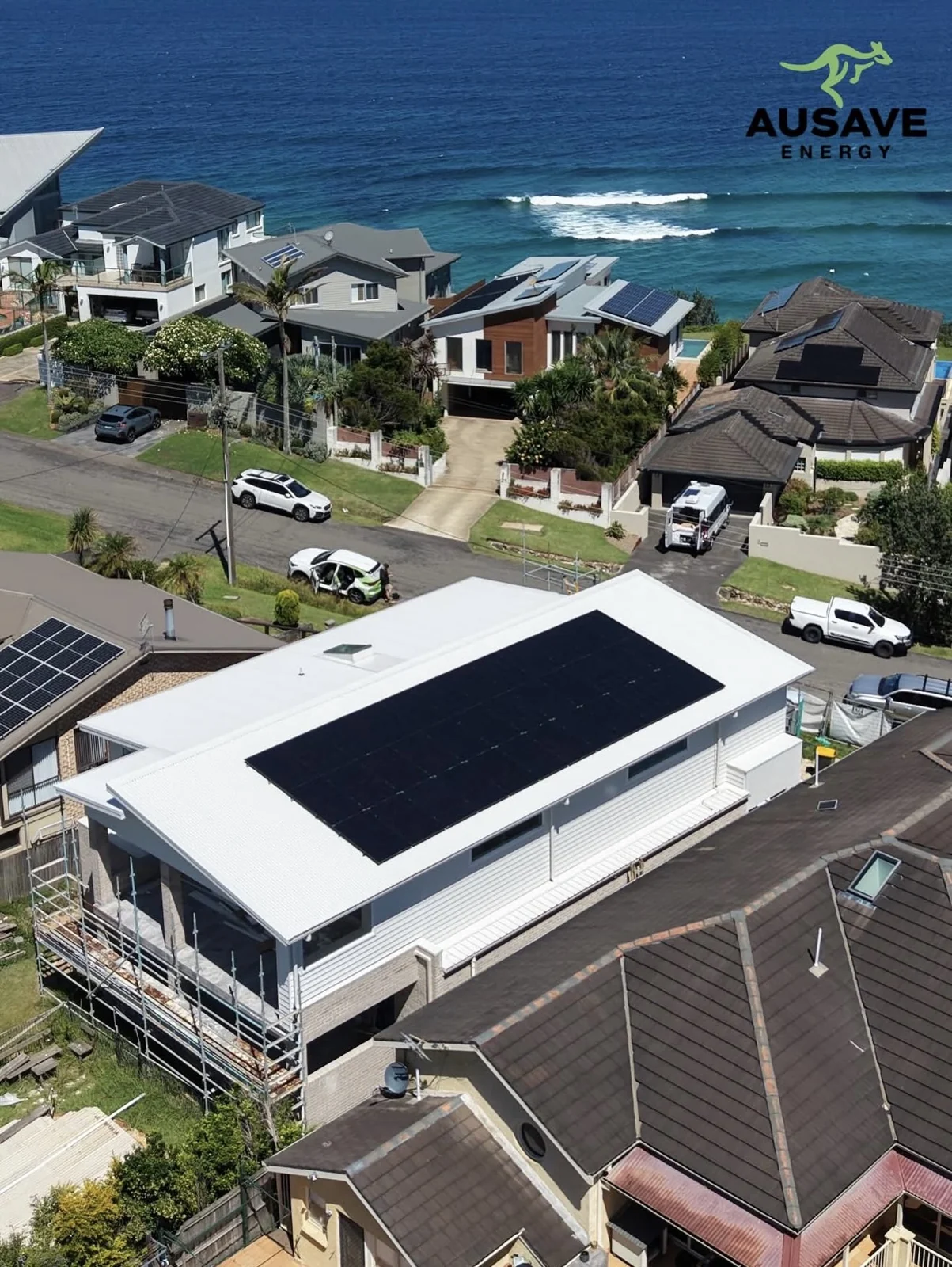 Aerial view of a beachfront home with rooftop solar